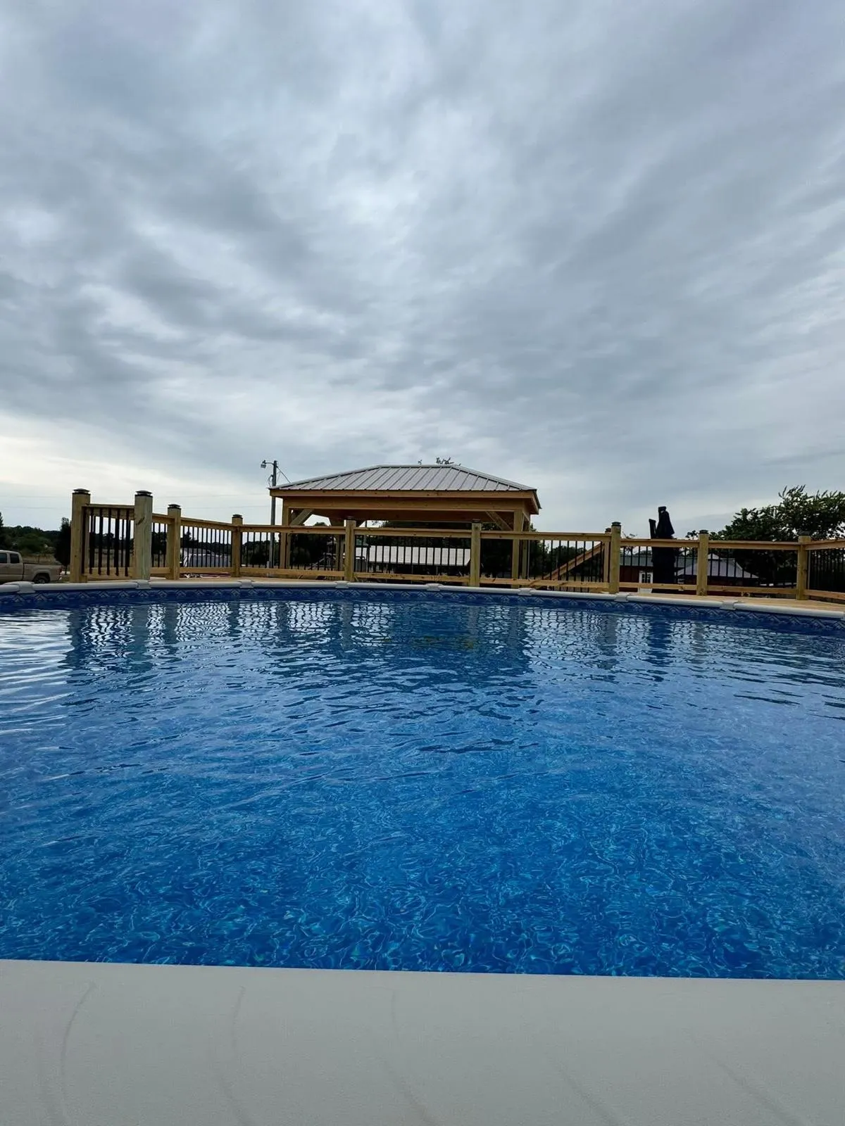 Freestanding covered outdoor structure beside a pool