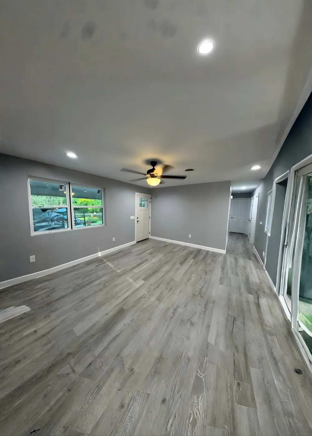 Open remodeled room with new wood-look flooring