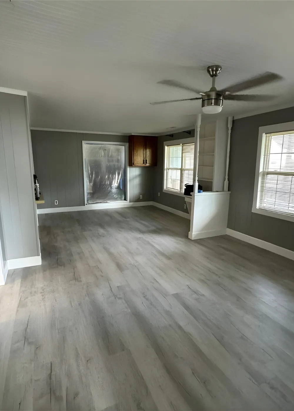Remodeled living area with updated flooring and trim